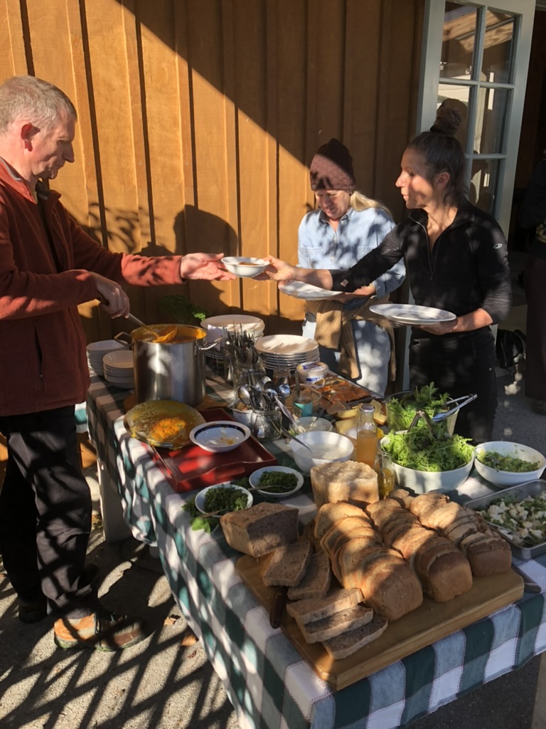 Sharing a meal together from local produce and pot-luck dishes from attendees.