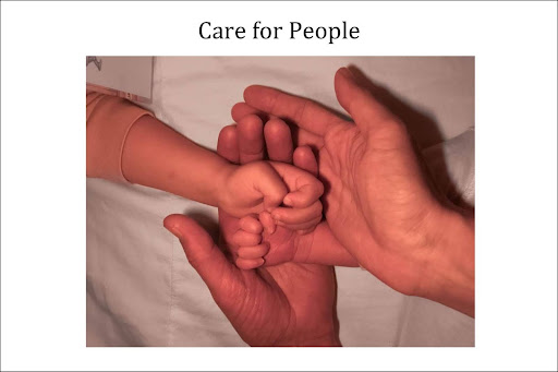 Image of two adult hands holding two baby hands