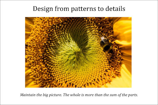 A close up photo of the centre of a sunflower showing the spiral pattern of seeds and a bee supping on it