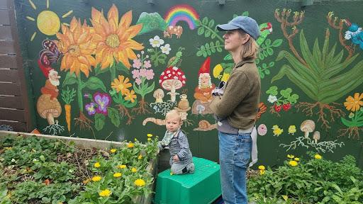 Child and mother learning permaculture in a garden